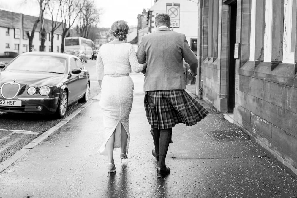 Back of bride and groom walking