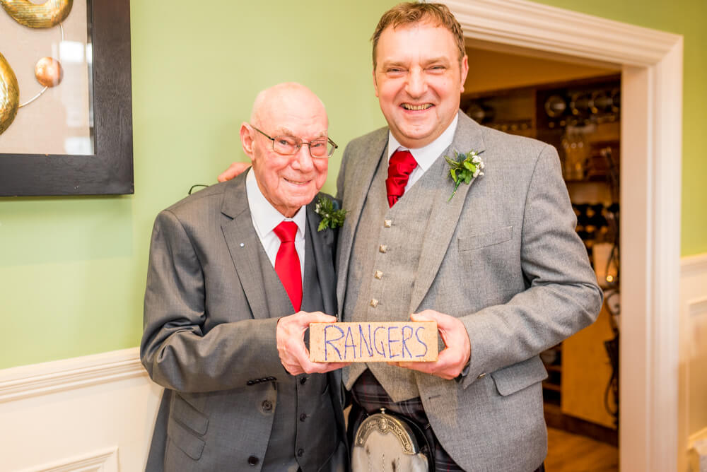 Father of the bride giving groom a Rangers brick