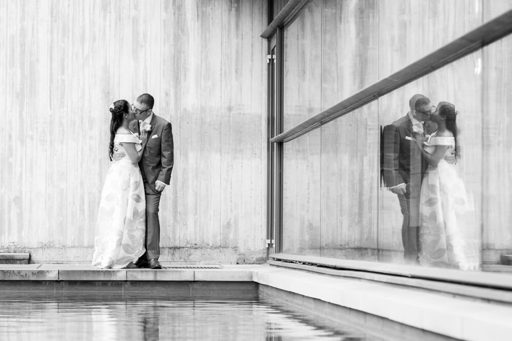 Bride and Groom kiss with reflection