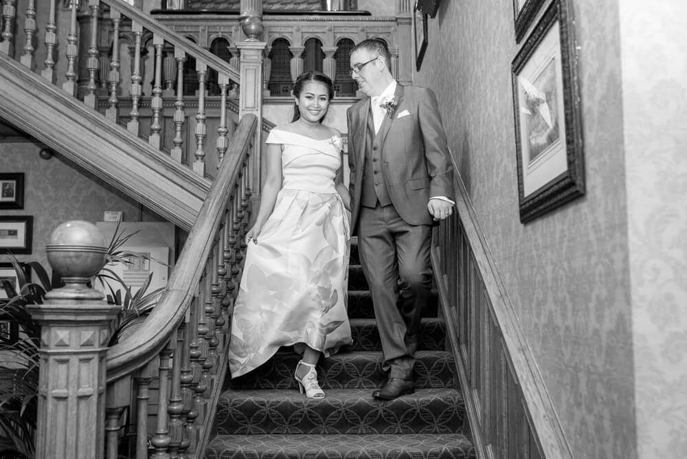 Bride and Groom walking down staircase