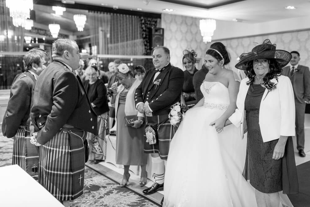 Bride walking down the aisle with mother at The Parkville Hotel